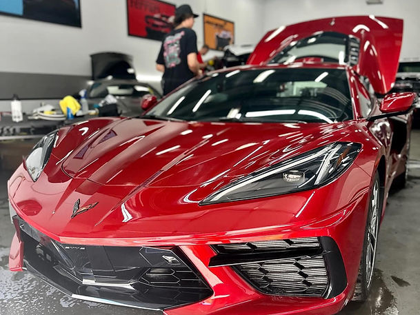 Glossy red sports car after ceramic coating by Texans Mobile Detail